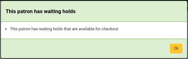 Pop up with the text This patron has waiting holds This patron has waiting holds that are available for checkout. There is an 'OK' button.